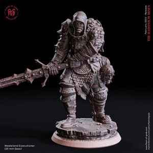 May include: A detailed miniature figure of a wasteland executioner, wearing a hooded cloak and armor, holding a sword and a severed head. The figure is standing on a rocky base. The miniature is painted in a dark gray color.