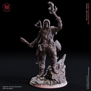 May include: A detailed miniature of Haemir, Human Explorer, holding a torch and a blade. The figure is clad in detailed explorer's attire, standing on a rocky base. The text "February 2023 - Release THE HADONIUM MINES" is visible.