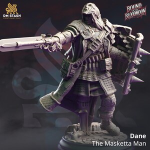 May include: A grey plastic miniature figure of a man wearing a hooded cloak and holding a sword and shield. The figure is standing on a base with the text "Dane The Masketta Man" printed on it. The figure is from the game "Bound in the Bloodmoon".