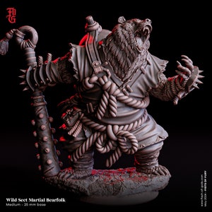 May include: A brown bear-like creature with a fierce expression, wearing a tattered brown robe and holding a spiked staff. The creature is standing on a rocky base. The text "Wild Sect Martial Bearfolk" and "Medium - 25 mm base" is visible below the figure.