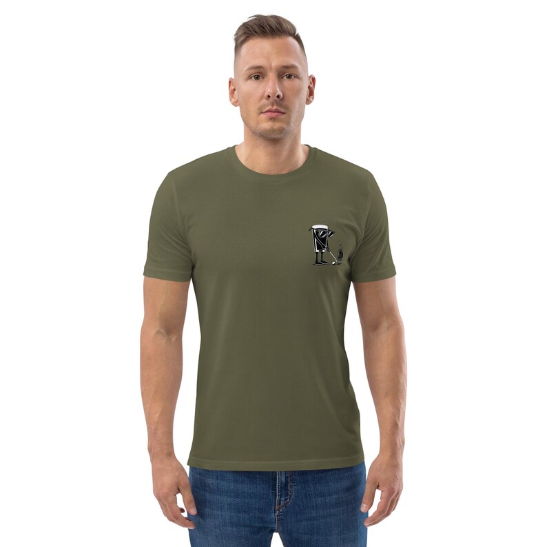 May include: Olive green t-shirt with a small black and white graphic on the left chest. The graphic depicts a person with a golf club and a golf bag. The shirt is made of a soft material.