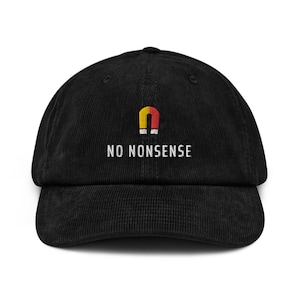 Può includere: Cappellino da baseball in velluto a coste nero con un grafico di calamita rosso e giallo e il testo "NO NONSENSE" ricamato in bianco.