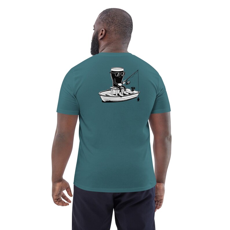 May include: Teal short-sleeve t-shirt featuring a black and white illustration of a beer glass fishing from a boat. The graphic shows the beer glass wearing sunglasses and holding a fishing rod. The shirt is made of a soft material.