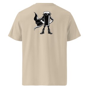 May include: A beige t-shirt with a black and white illustration of a beer glass superhero. The beer glass is wearing sunglasses, a cape, and boots, with its hands on its hips. The design is on the back.
