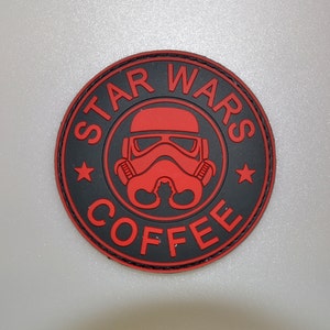 May include: A circular patch in black and red, featuring the text "STAR WARS COFFEE" around a red Stormtrooper helmet. Two red stars are on either side of the helmet. The patch has a stitched edge.