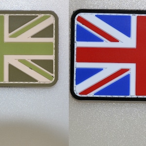May include: Two rectangular patches featuring the Union Jack flag. One patch has a green, tan, and olive color scheme. The other patch has a red, white, and blue color scheme, with a black border.