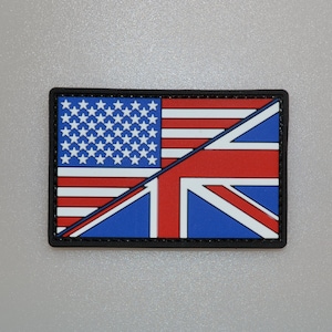 May include: Rectangular patch featuring a split design of the American and British flags. The American side displays white stars on a blue field with red and white stripes. The British side shows the Union Jack in red, white, and blue, all within a black border.