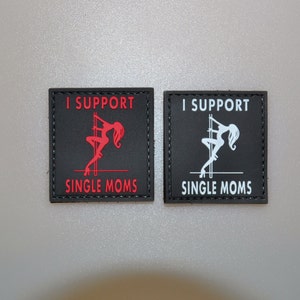 May include: Two black square patches with the text "I SUPPORT SINGLE MOMS". One patch has red text and a red silhouette of a woman pole dancing. The other patch has white text and a white silhouette.