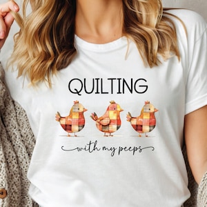 May include: White t-shirt with the text "QUILTING with my peeps" and three cartoon chicks with patchwork designs.