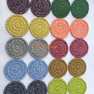 May include: Set of 18 crocheted coasters in various colors, including green, yellow, gray, blue, red, black, and brown. The coasters are circular and have a textured design.