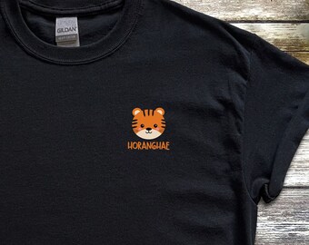 May include: Black t-shirt with a small orange and brown cartoon tiger face and the word "HORANGHAE" in orange text.