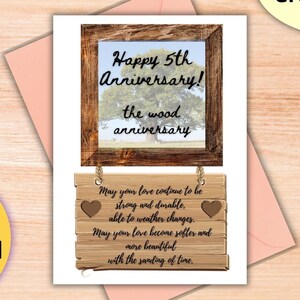 May include: Printable greeting card with a woodgrain background. The card features a picture frame with a photo of a tree and the text "Happy 5th Anniversary! The wood anniversary". Below the frame is a wooden sign with a heart and the text "May your love continue to be strong and durable, able to weather changes. May your love become softer and more beautiful with the sanding of time."