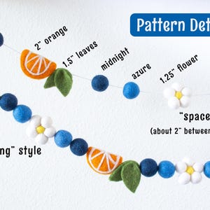 May include: A felt ball garland featuring orange slices, green leaves, white flowers with yellow centers, and blue spheres in midnight and azure shades. Text labels indicate sizes like 2 inch orange, 1.5 inch leaves, and 1.25 inch flower, plus spacing styles.