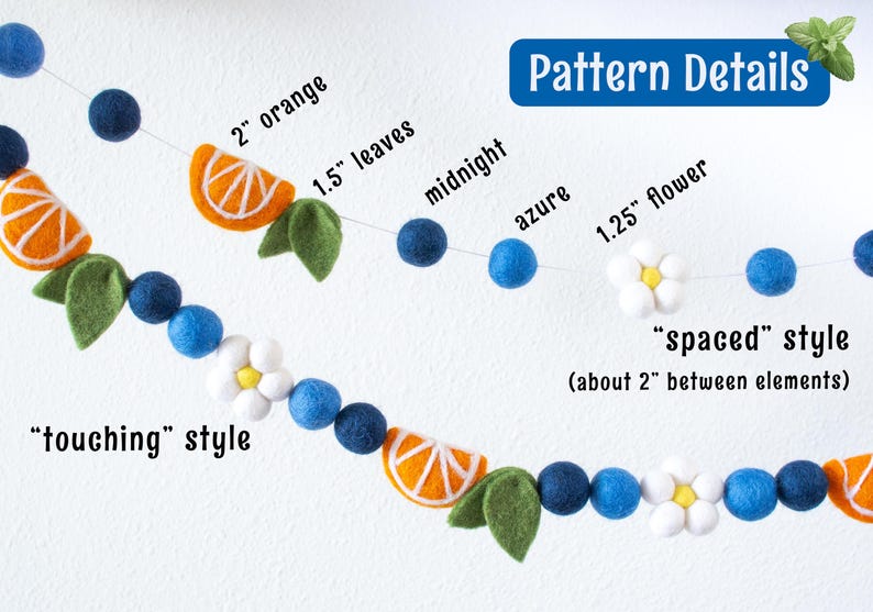 May include: A felt ball garland featuring orange slices, green leaves, white flowers with yellow centers, and blue spheres in midnight and azure shades. Text labels indicate sizes like 2 inch orange, 1.5 inch leaves, and 1.25 inch flower, plus spacing styles.