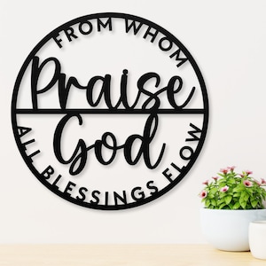 May include: Black metal wall decor with the text "From Whom All Blessings Flow Praise God" in a circle.