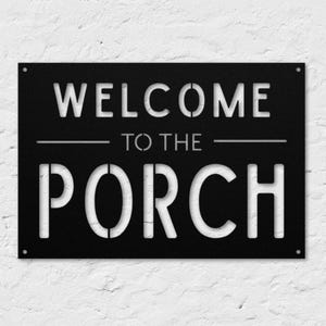 May include: Black metal sign with white lettering that reads "Welcome to the Porch".