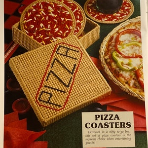 May include: A set of four brown and red pizza coasters in a box with the word "PIZZA" embroidered on the box. The coasters are in a to-go box with a red ribbon.