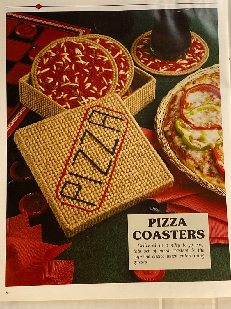 May include: A set of four brown and red pizza coasters in a box with the word "PIZZA" embroidered on the box. The coasters are in a to-go box with a red ribbon.