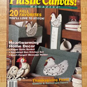 May include: A magazine cover titled "Plastic Canvas!" features a variety of fall-themed craft projects. The cover includes images of stitched hen-themed home decor items, including a tissue box cover, message holder, and a basket. The text reads "20 Fall Favorites You'll Love to Stitch!"