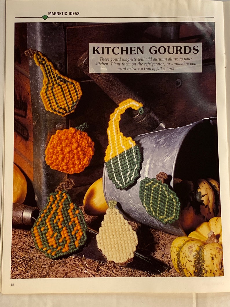 May include: A set of six colorful gourd-shaped magnets with a green, orange, and yellow color scheme. The magnets are arranged on a rustic background with a metal bucket and gourds. "Kitchen Gourds" is written in the image.
