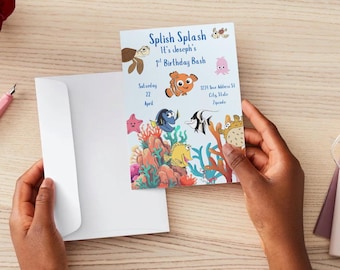 May include: A birthday invitation with the text "Splish Splash It's Joseph's 1st Birthday Bash". The invitation features cartoon sea creatures, including a turtle, clownfish, and starfish, with coral and seaweed illustrations. The invitation is held in a white envelope.