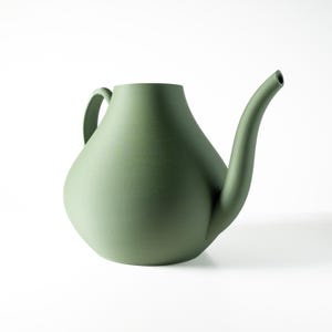 May include: A green plastic watering can with a long spout and a handle. The watering can is designed to look like a teapot.