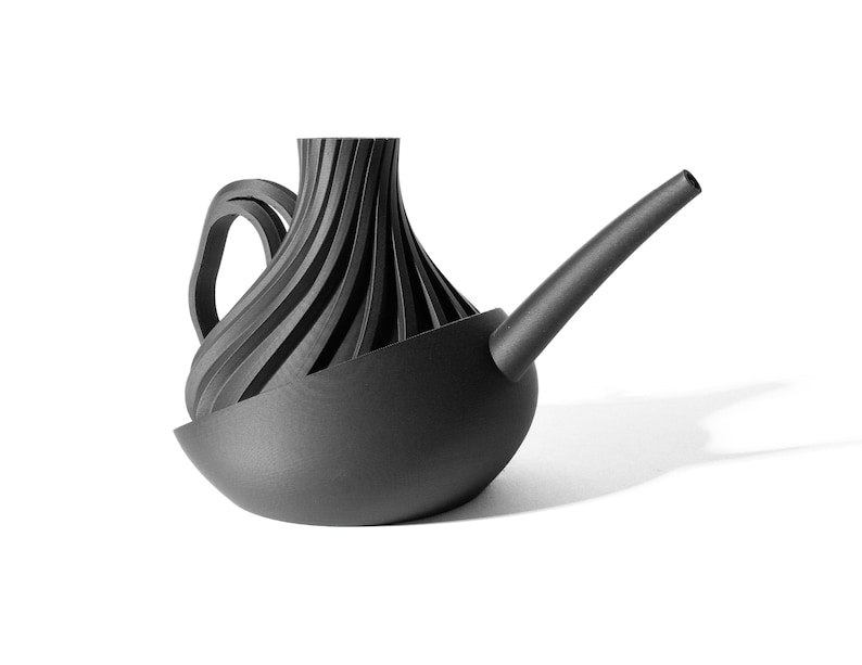 May include: A black watering can with a unique, ribbed design and a long spout. The can has a rounded base and a handle.