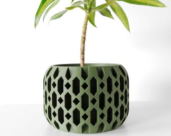 May include: A green planter with a geometric pattern. The planter is made of a durable material and has a modern design.