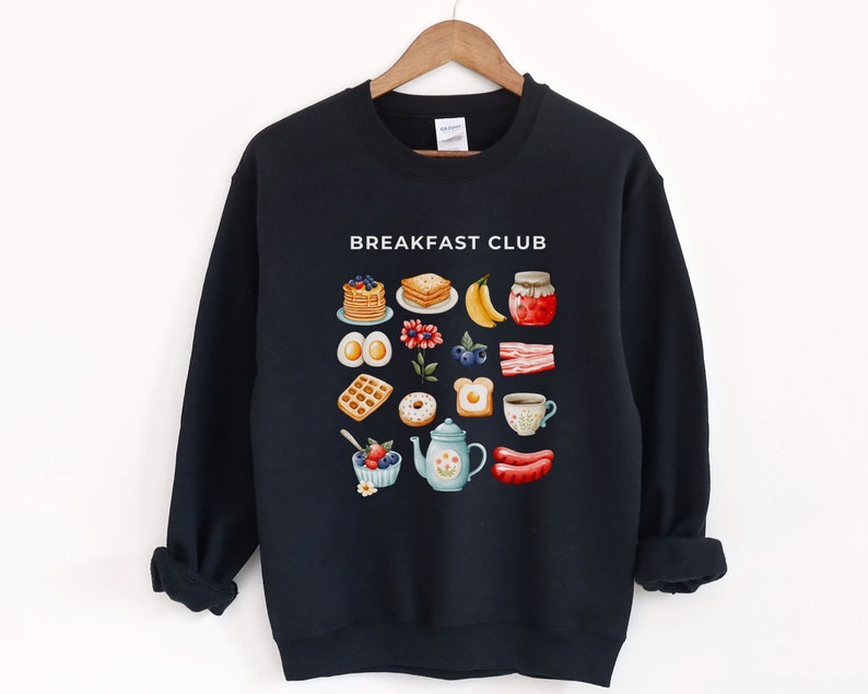 May include: Black sweatshirt with a white graphic of breakfast foods and the text "Breakfast Club".