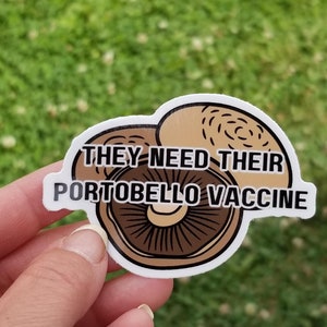 May include: A white sticker with a brown mushroom illustration and the text "They need their portobello vaccine".