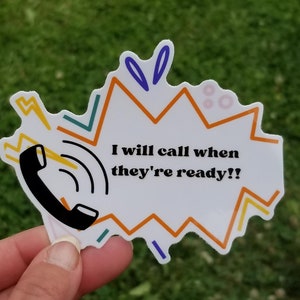 May include: A white sticker with a black phone and a yellow lightning bolt. The sticker has a speech bubble with the text "I will call when they're ready!!" in black text. The speech bubble is surrounded by orange, yellow, blue, and green lines.