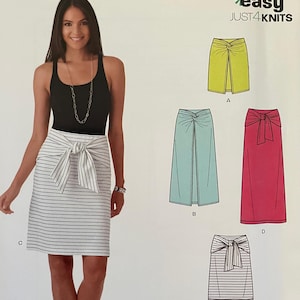 May include: A sewing pattern for a skirt with a tie at the waist. The pattern includes four different styles of skirts: a yellow skirt with a front slit, a light blue skirt, a pink skirt, and a striped skirt. The pattern is called "easy JUST4KNITS" and is from New Look.