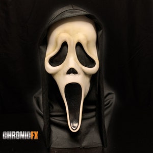 May include: A Scream mask with a pale, off-white face and large, black eye sockets and mouth. The mask is framed by a black hood, creating a stark contrast against the dark background. The text "CHRONICFX" is visible at the bottom.