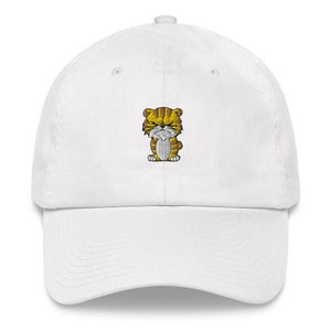 May include: White baseball cap with an embroidered cartoon tiger in orange and brown.