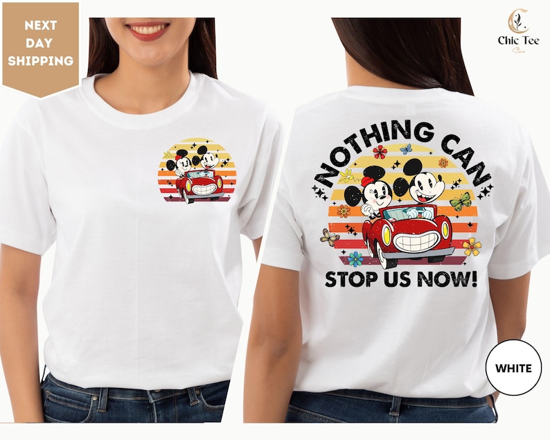 a woman wearing a white t - shirt with mickey mouse on it