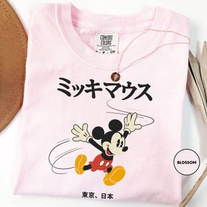 a pink tshirt with a mickey mouse on it