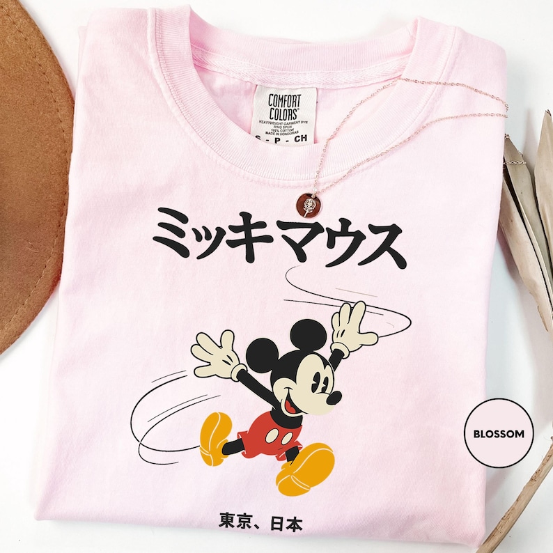 a pink tshirt with a mickey mouse on it