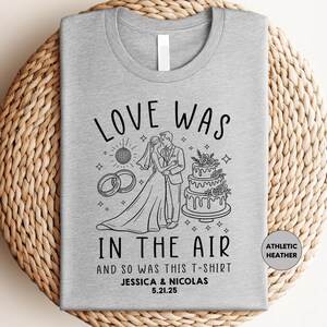 a t - shirt that says love was in the air and so was this t