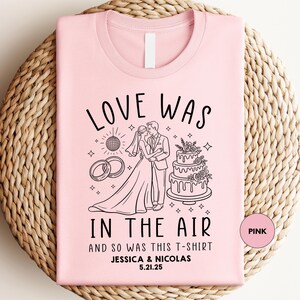 a pink t - shirt with a picture of a bride and groom