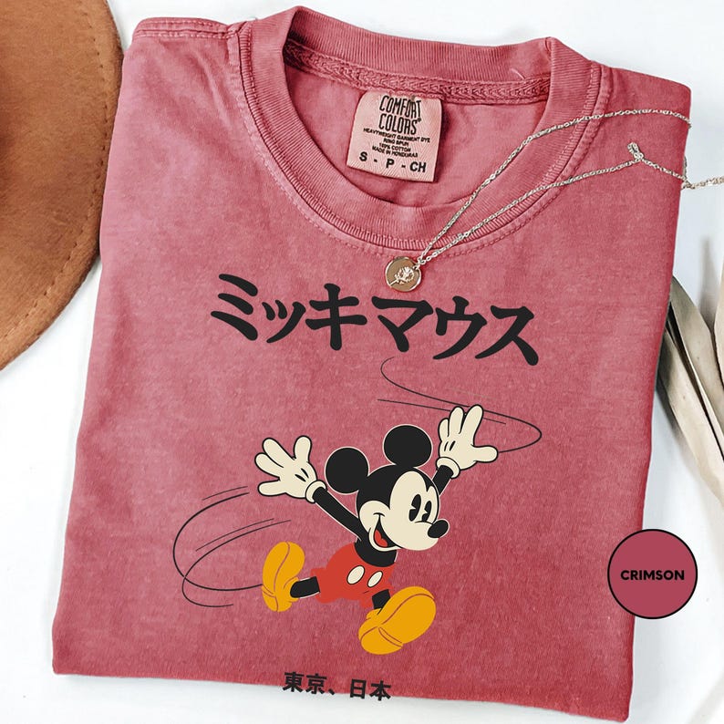 a mickey mouse tshirt with a hat on top of it