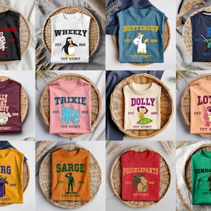 May include: A collection of twelve short-sleeved t-shirts in various colors, each featuring a unique Toy Story character graphic, the character's name in bold lettering, an established year, and the text Toy Story printed below the illustration.