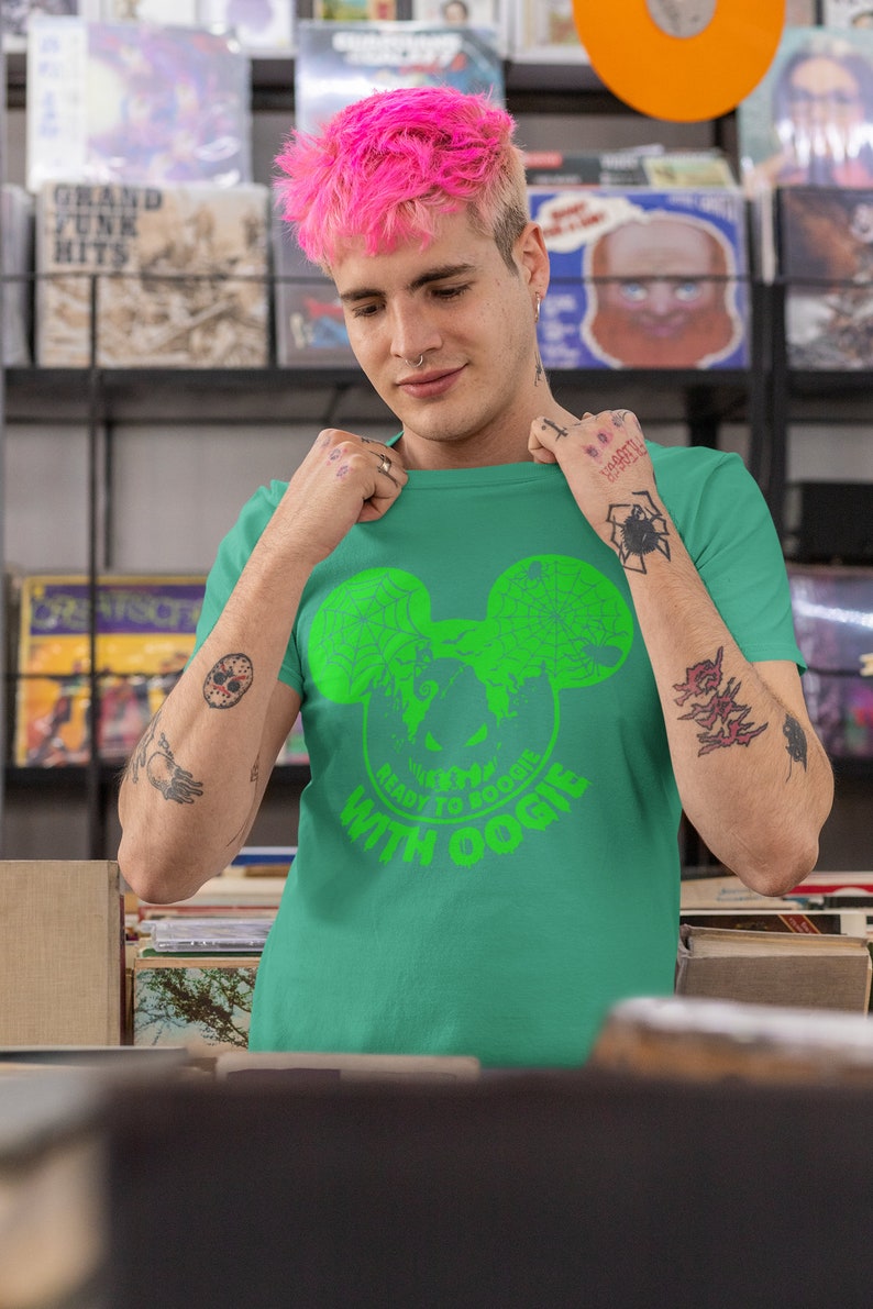 May include: A green t-shirt with a green Mickey Mouse head graphic. The graphic has a spider web design and the text "Ready to Boogie with Oogie".