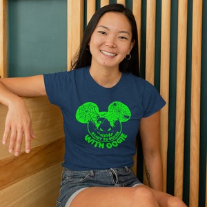 May include: A navy blue t-shirt with a green graphic of a Mickey Mouse head with a spiderweb design. The text "Ready to Boogie with Oogie" is printed below the graphic.