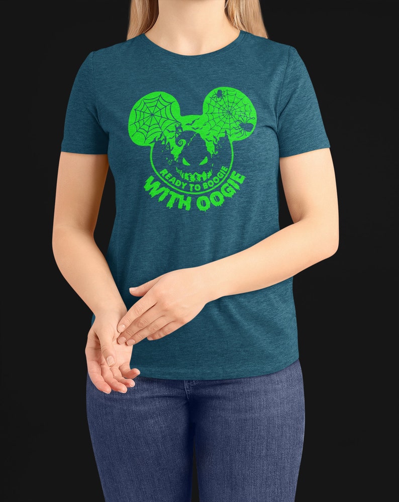 May include: A teal blue t-shirt with a green graphic of a Mickey Mouse head with a spider web and a pumpkin face inside. The text "Ready to Boogie with Oogie" is written below the graphic.