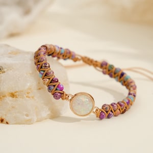 May include: A brown leather bracelet with a white opal gemstone and multi-colored beads.