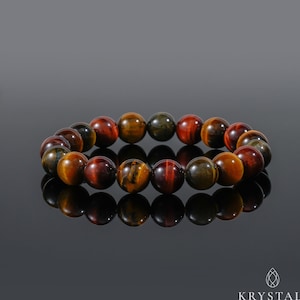 May include: A bracelet made of tiger's eye beads in shades of red, gold, and green. The beads are round and polished, and the bracelet is strung on elastic.