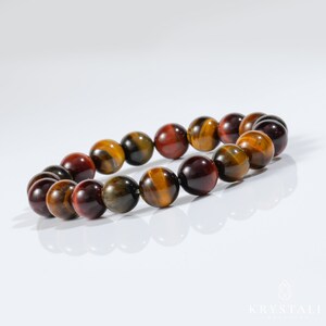 May include: A bracelet made of tiger's eye beads in shades of red, gold, and brown.
