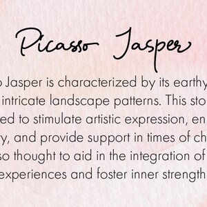 May include: Text on a pink and white watercolor background reads "Picasso Jasper." The text below describes the stone's earthy colors, landscape patterns, and its believed properties to stimulate artistic expression and creativity.