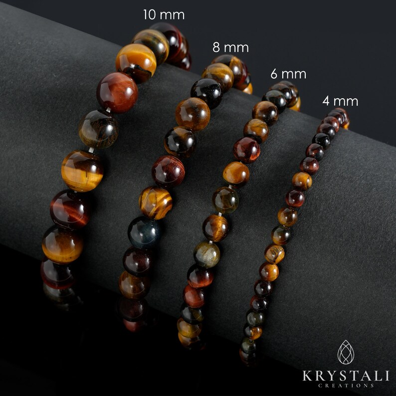 May include: Four tiger's eye bracelets in different sizes, 4 mm, 6 mm, 8 mm, and 10 mm. The bracelets are made of natural tiger's eye beads and are displayed on a dark gray surface.