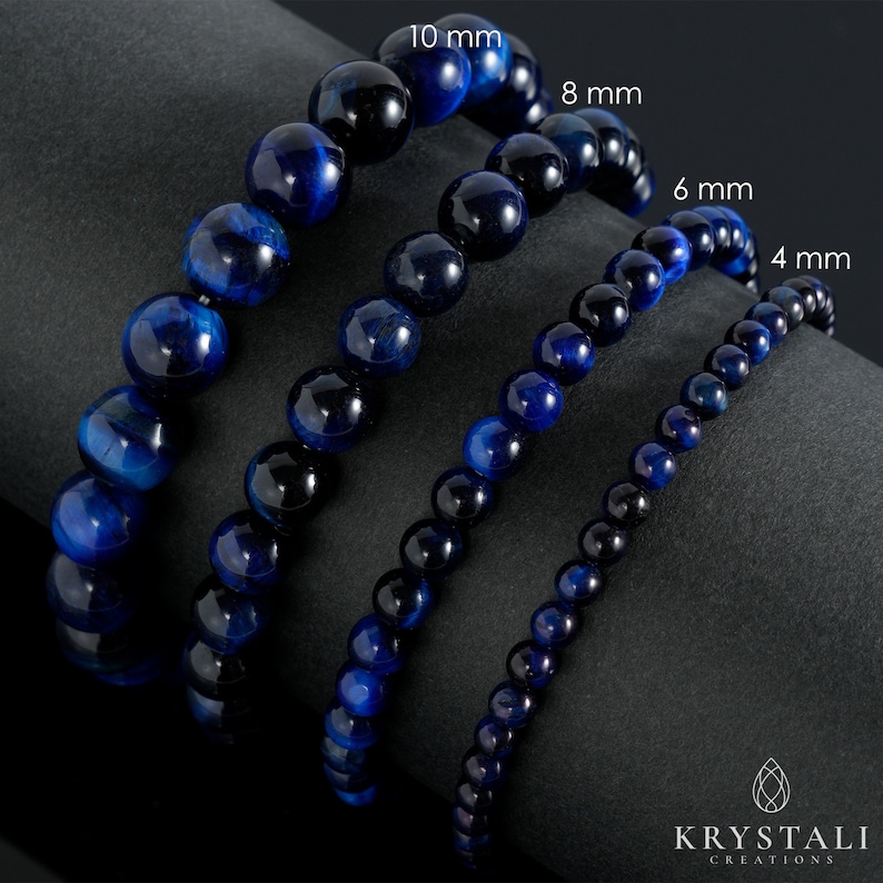 May include: Four blue tiger's eye gemstone bracelets with different bead sizes: 4 mm, 6 mm, 8 mm, and 10 mm. The bracelets are arranged in order of size, with the smallest bracelet at the bottom and the largest bracelet at the top.